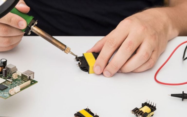 Man fixing a connector using the soldering iron