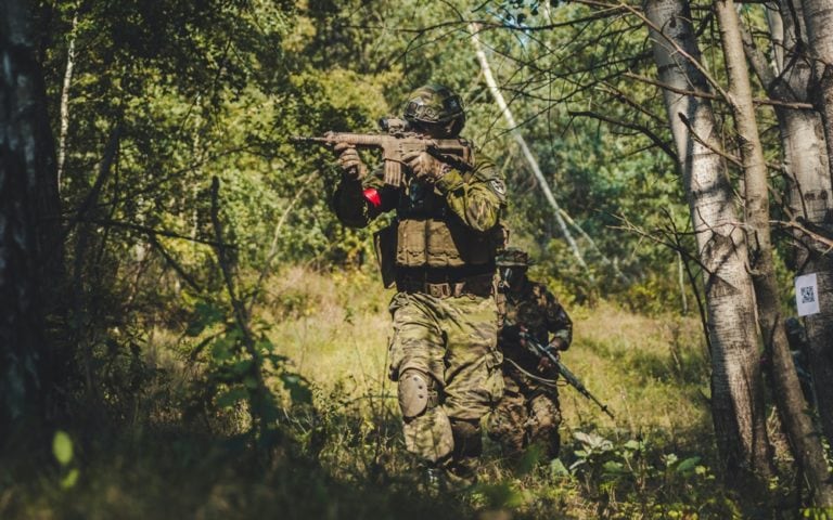 Special forces soldier assault rifle with silencer.