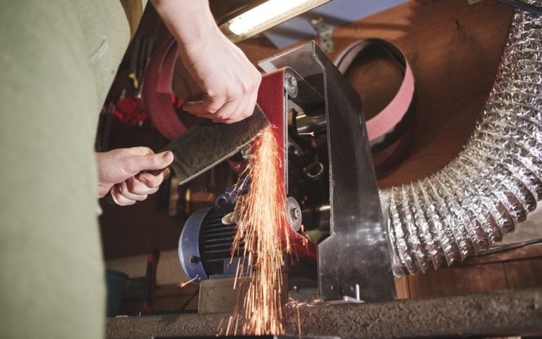 Man sharpening a knife in the workshop