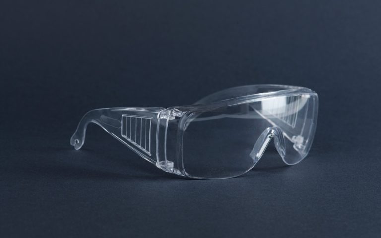 Clear goggles on a dark blue surface